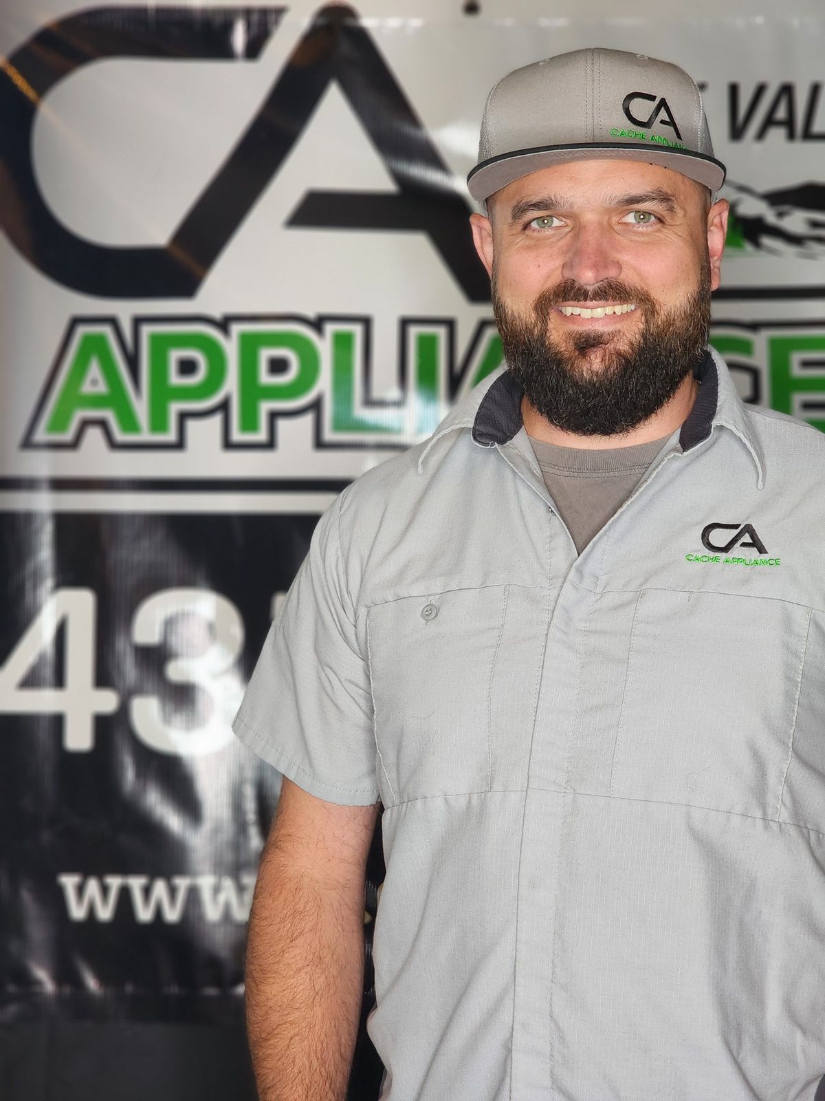 Cache Appliance technician in front of the Cache Appliance banner
